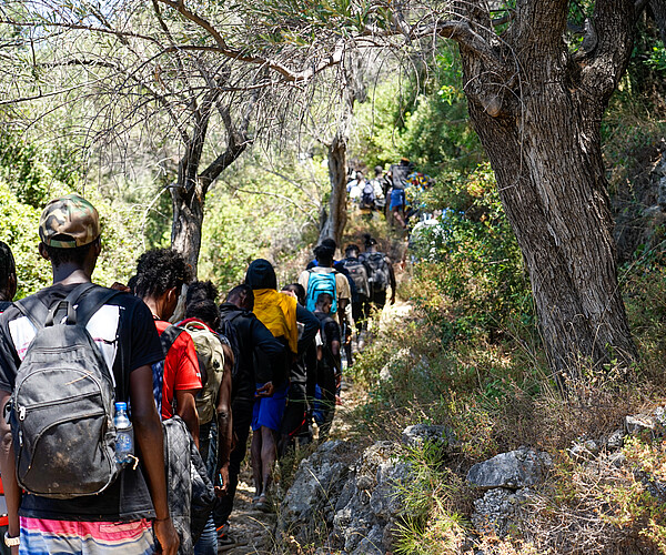 Neuankommende Geflüchtete gehen einen felsigen Weg auf der Insel Samos entlang. Viele Menschen verstecken sich nach ihrer Ankunft in den Hügeln oder Bergen, da sie nach eigenen Angaben Angst haben, von den Grenztruppen gefunden und zur Rückkehr gezwungen zu werden. Bild: Alice Gotheron/MSF